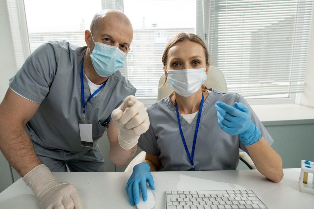 Two dental professionals discussing patient outreach and visibility strategies powered by a local SEO agency.